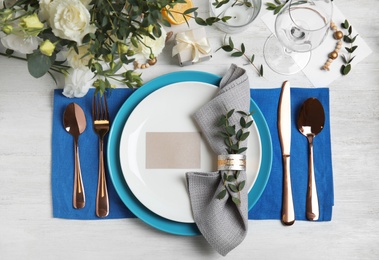 Elegant festive table setting on white wooden background, flat lay