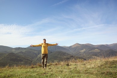 Man enjoying beautiful mountain landscape on sunny day
