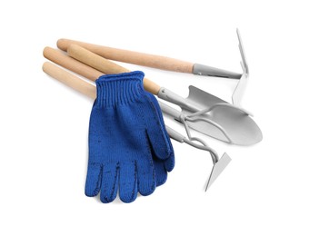 Pair of gloves and gardening tools on white background, top view