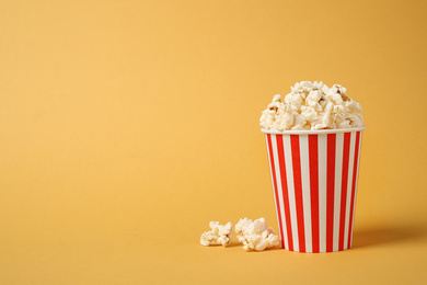 Delicious popcorn on yellow background. Space for text