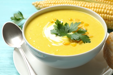 Delicious creamy corn soup served on turquoise wooden table