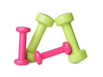 Colorful dumbbells on white background. Weight training equipment