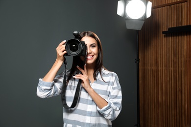 Professional photographer taking picture in modern studio