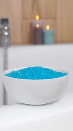 Bowl with sea salt on white bath
