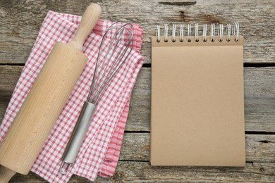 Photo of Blank recipe book and kitchen utensils on old wooden table, flat lay. Space for text