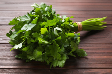 Bunch of fresh green parsley on wooden table, closeup