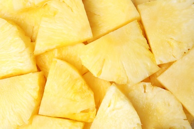 Slices of tasty ripe pineapple as background, top view