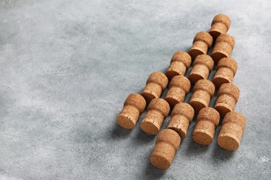 Photo of Christmas tree made of wine corks on grey table. Space for text