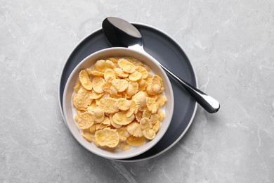 Tasty cornflakes with milk served on light grey table, top view