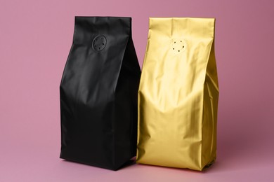 Different blank foil packages on pink background