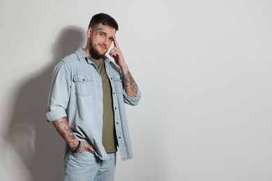 Photo of Portrait of hipster man on light grey background. Space for text