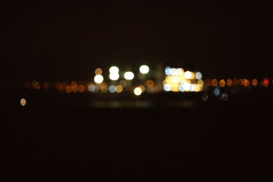 Blurred view of bulk carrier in roads at night. Bokeh effect