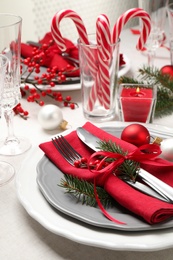 Festive table setting with beautiful dishware and Christmas decor on white background