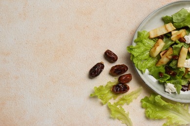 Photo of Delicious parsnip with lettuce, feta cheese and dates on beige table, flat lay. Space for text