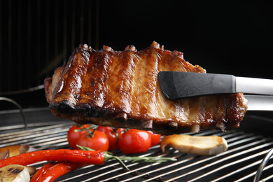 Delicious ribs and vegetables on barbecue grill