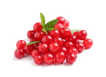 Photo of Pile of fresh ripe cranberries with leaves on white background