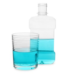 Bottle and glass with mouthwash on white background. Oral hygiene