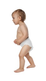 Photo of Cute baby in diaper learning to walk on white background