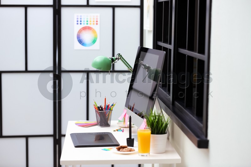 Modern designer's workplace with graphic tablet and computer