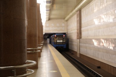 Train pulling out of subway station, blurred view. Public transport