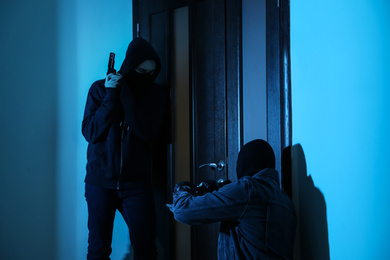 Dangerous criminals forcing door with crow bar