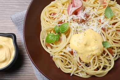 Delicious spaghetti with meat and cheese sauce on wooden table, flat lay