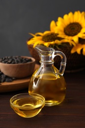 Sunflower oil in glass bowl and jug on wooden table