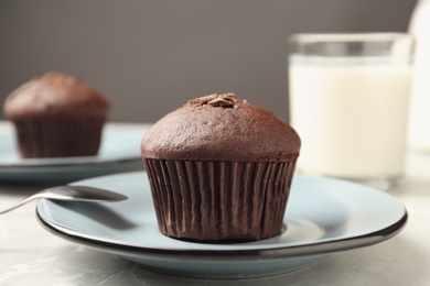 Delicious cupcake with chocolate crumbles on grey table, closeup