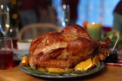 Festive dinner with delicious baked turkey served on table indoors, closeup. Christmas celebration