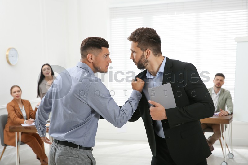 Emotional colleagues fighting in office. Workplace conflict