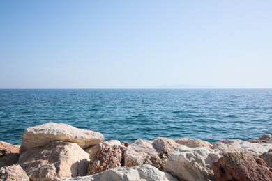 Photo of Beautiful view of rocky beach and calm sea on sunny day