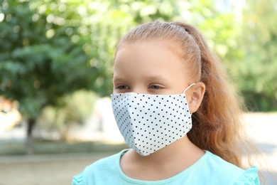 Preteen girl in protective face mask outdoors