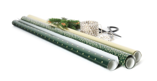 Wrapping paper rolls, rope, fir branches and scissors on white background