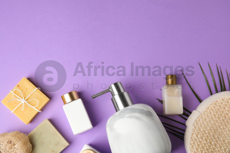 Flat lay composition with marble soap dispenser on violet background. Space for text
