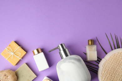 Flat lay composition with marble soap dispenser on violet background. Space for text