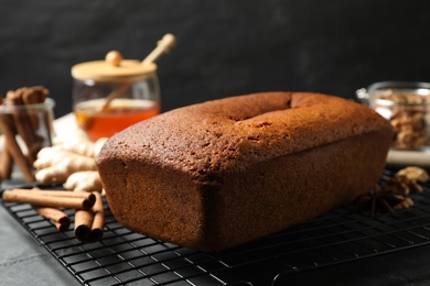 Photo of Delicious gingerbread cake and ingredients on cooling rack