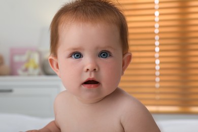Photo of Portrait of cute little redhead baby at home