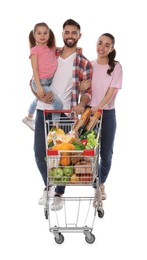 Happy family with shopping cart full of groceries on white background