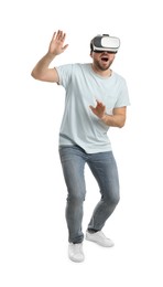Emotional man using virtual reality headset on white background