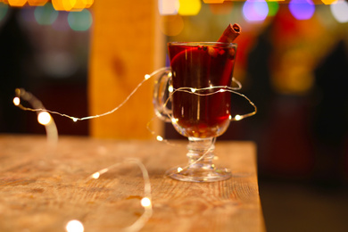 Tasty aromatic mulled wine on table at winter fair