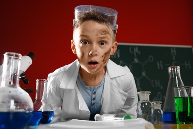 Photo of Emotional child in laboratory after explosion. Dangerous experiment