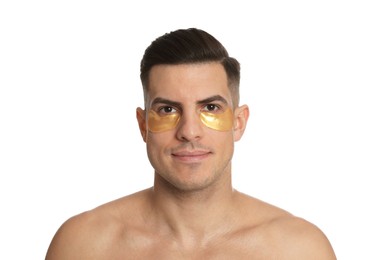 Man with golden under eye patches on white background