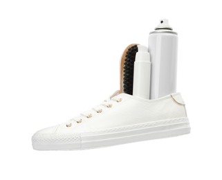Stylish footwear with shoe care accessories on white background