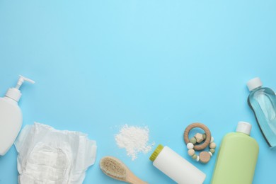 Photo of Flat lay composition with dusting powder and other baby care products on light blue background, space for text