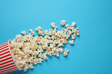 Delicious popcorn on light blue background, top view