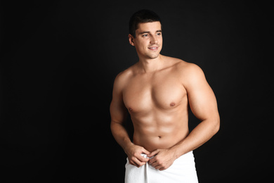 Man with sexy body on black background. Space for text