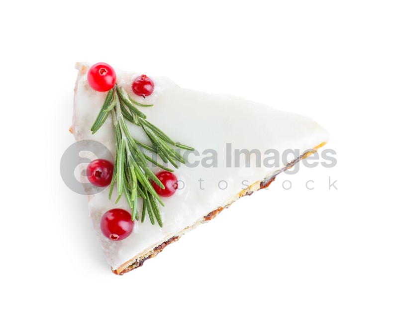 Photo of Slice of traditional Christmas cake decorated with rosemary and cranberries isolated on white, top view