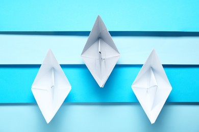 Competition concept. Paper boats on colorful background, flat lay