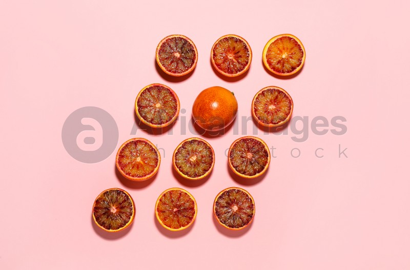 Many ripe sicilian oranges on pink background, flat lay
