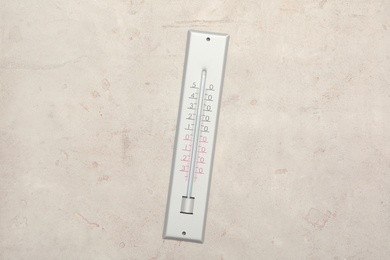 Weather thermometer on light background, top view